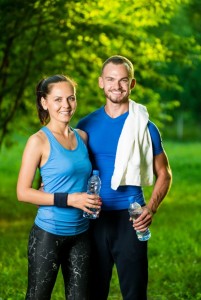 Man and woman drinking water from bottle after fitness sport exercise